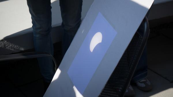 A partial solar eclipse projected on cardboard.